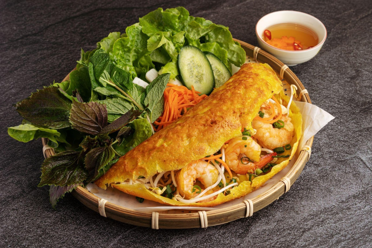Crispy Banh Xeo pancake filled with shrimp, pork, and bean sprouts