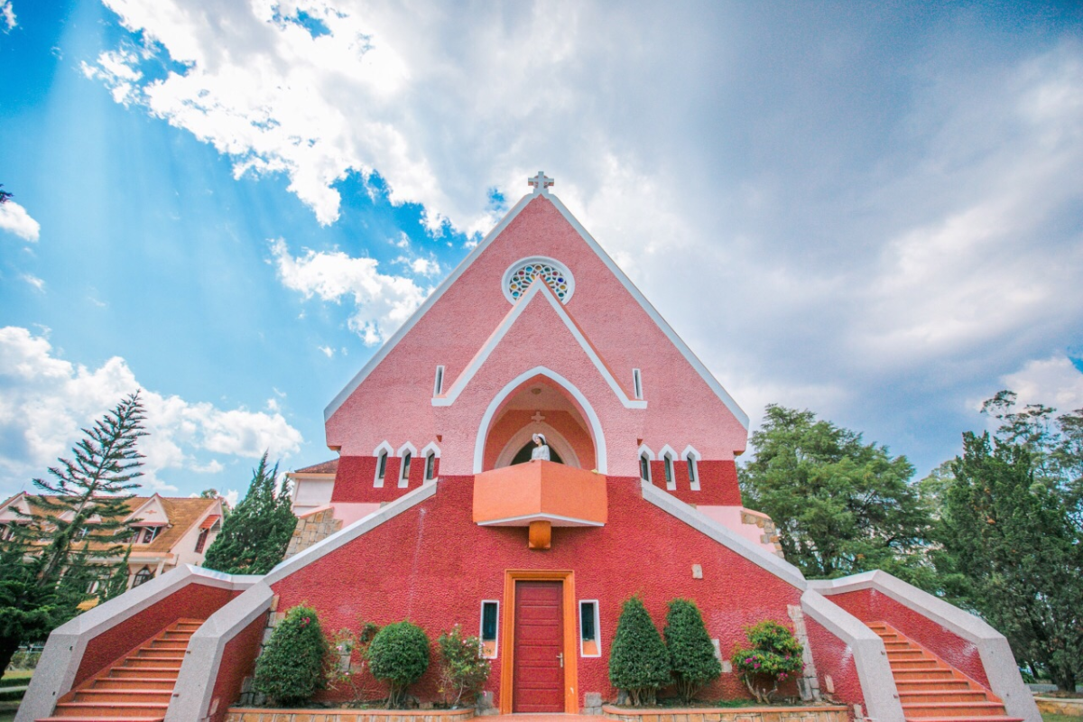 Domaine de Marie Church with pink facade and Central Highlands-inspired architecture