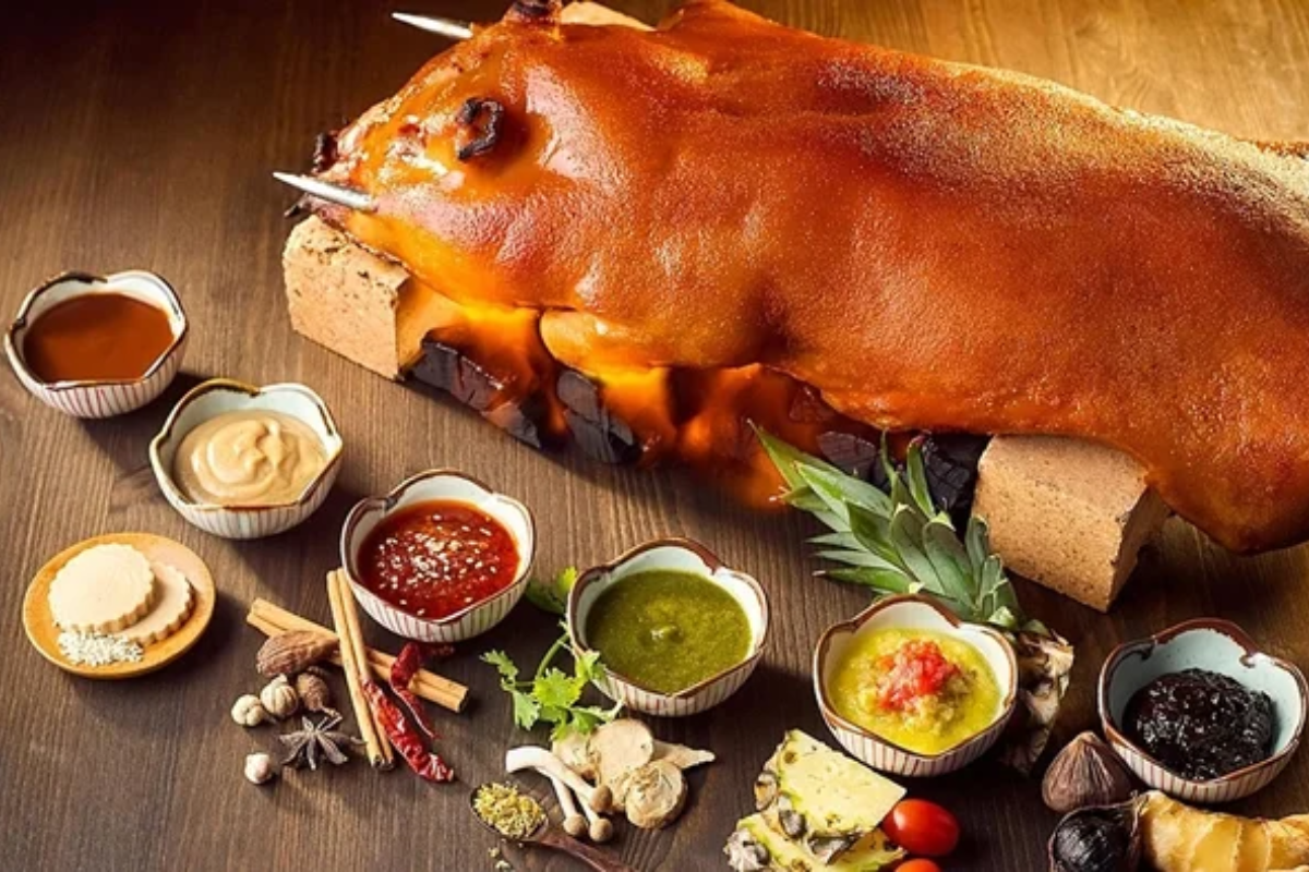 Grilled Sapa dwarf pig meat seasoned with mac khen and served with herbs