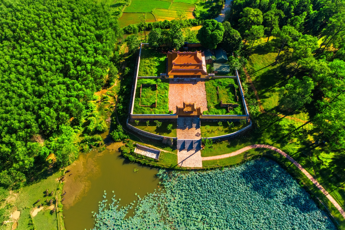 Moss-covered structures at Gia Long Tomb surrounded by natural greenery
