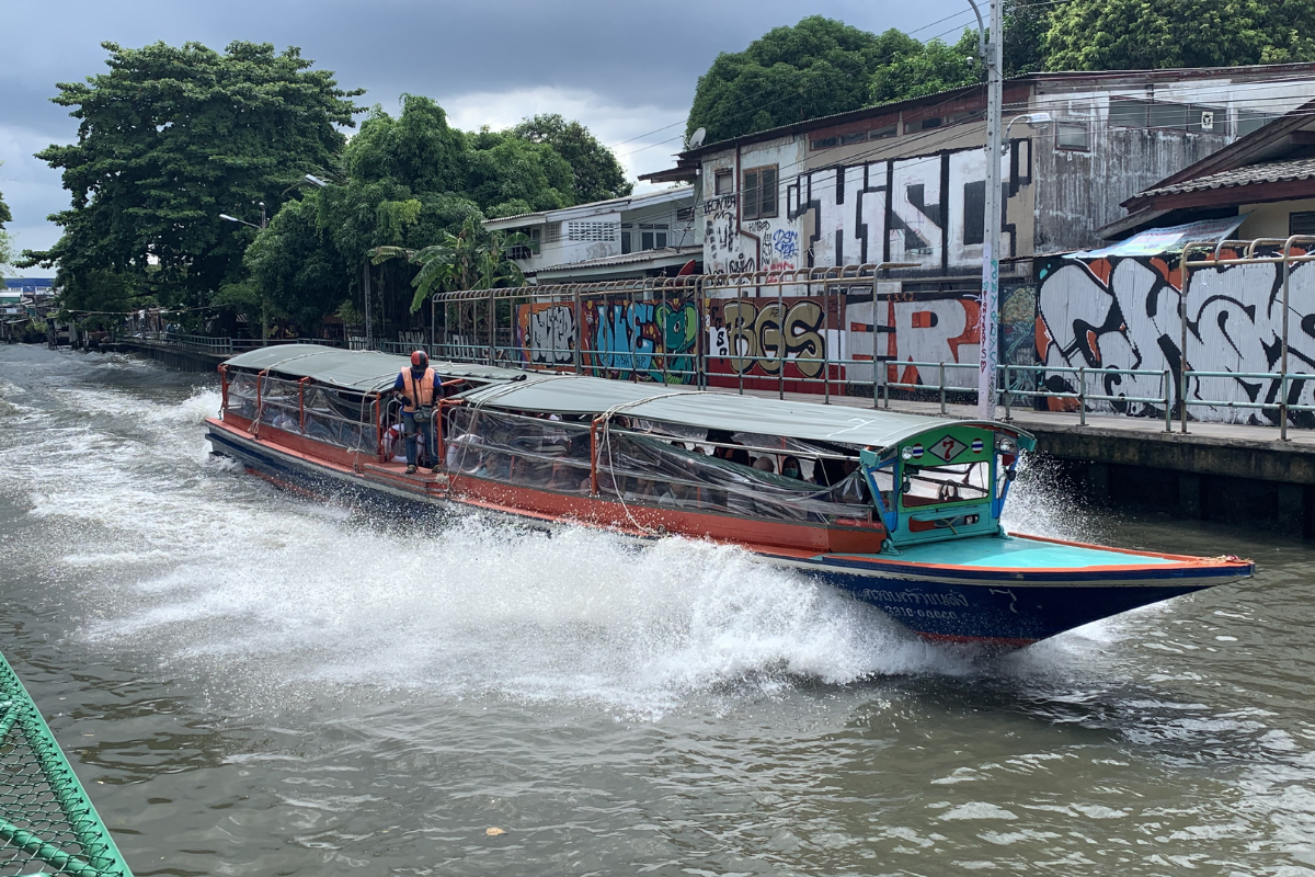 Khlong Saen Saep boat passing traditional Thai houses on a canal