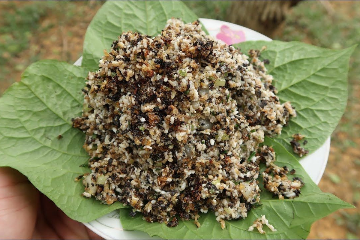 Sticky rice with ant eggs and fried shallots, served on a banana leaf
