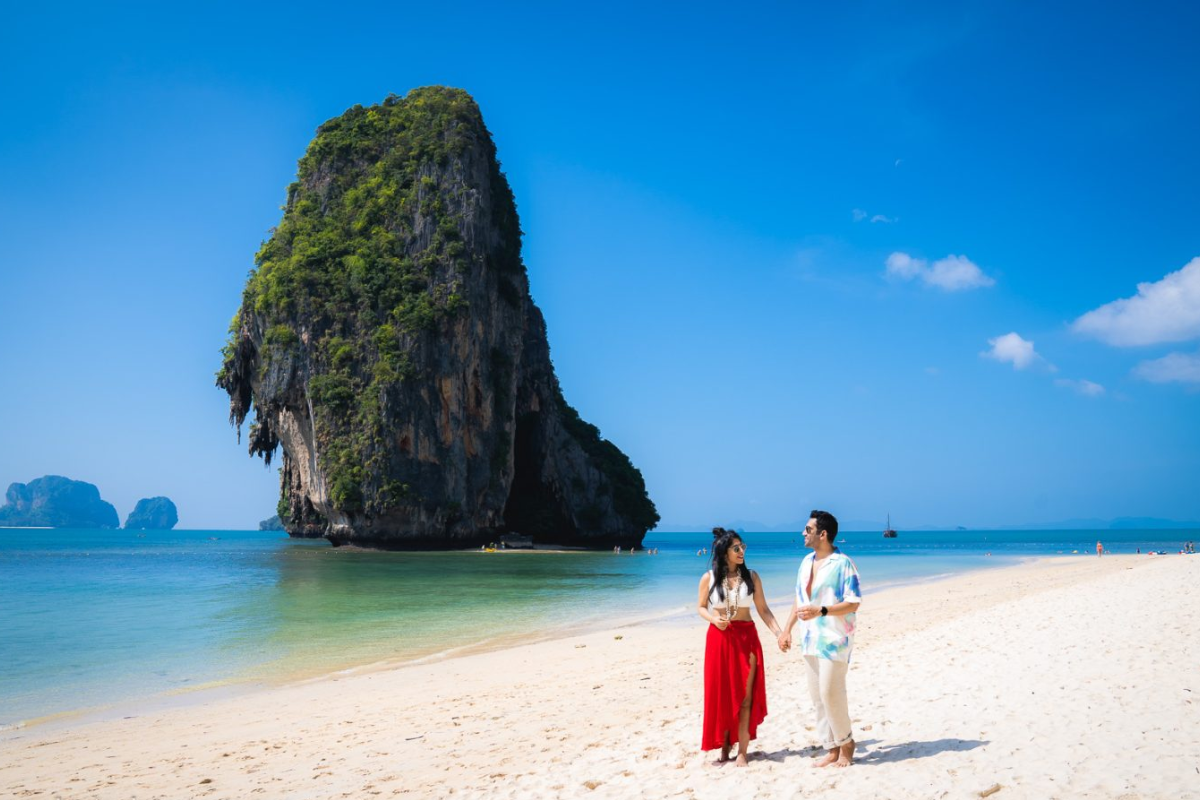 Tourists enjoying a sunny day on a crowded Phuket beach in January
