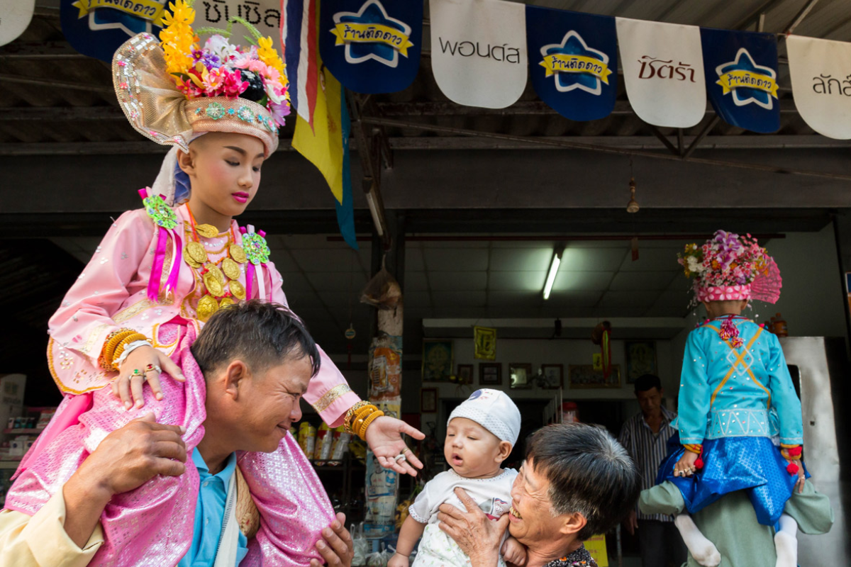 Young boys in colorful prince costumes during Poi Sang Long ordination parade in Thailand