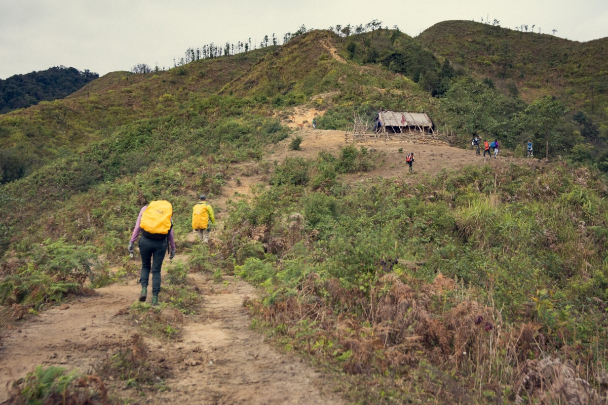 Hiker on Pu Si Lung Peak with sweeping mountain views in Lai Chau, Vietnam