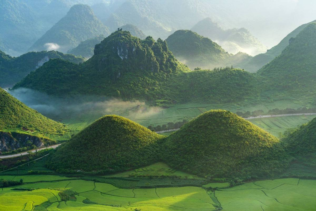 Quan Ba Twin Mountains rising symmetrically amid misty hills