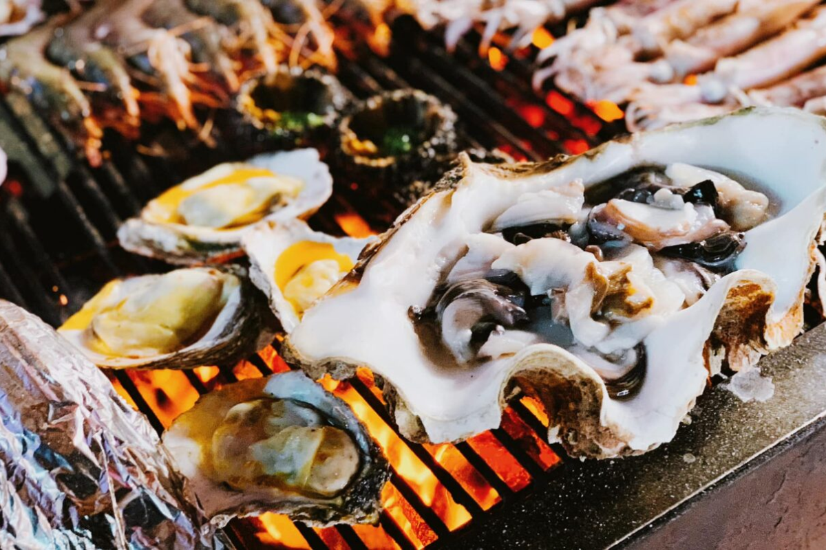 Plates of grilled seafood and lobster served at a beachside restaurant in Con Dao