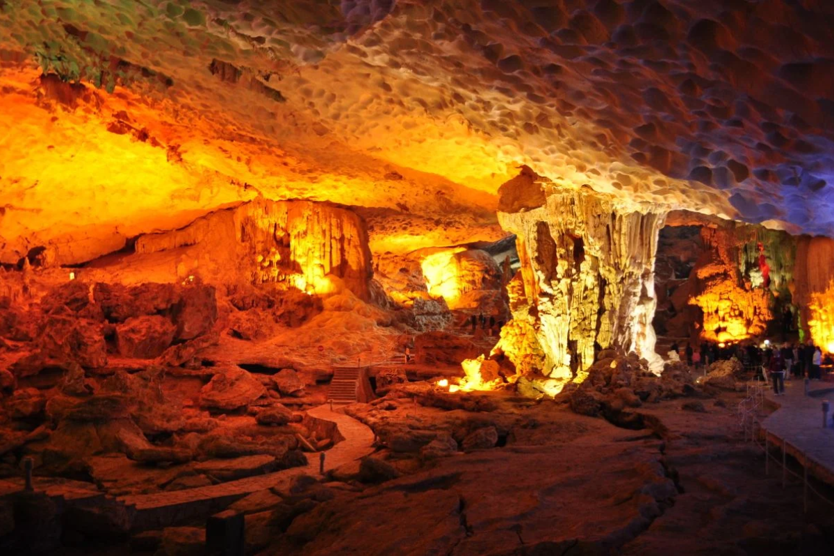 Interior of Sung Sot Cave with illuminated rock formations and stalactites