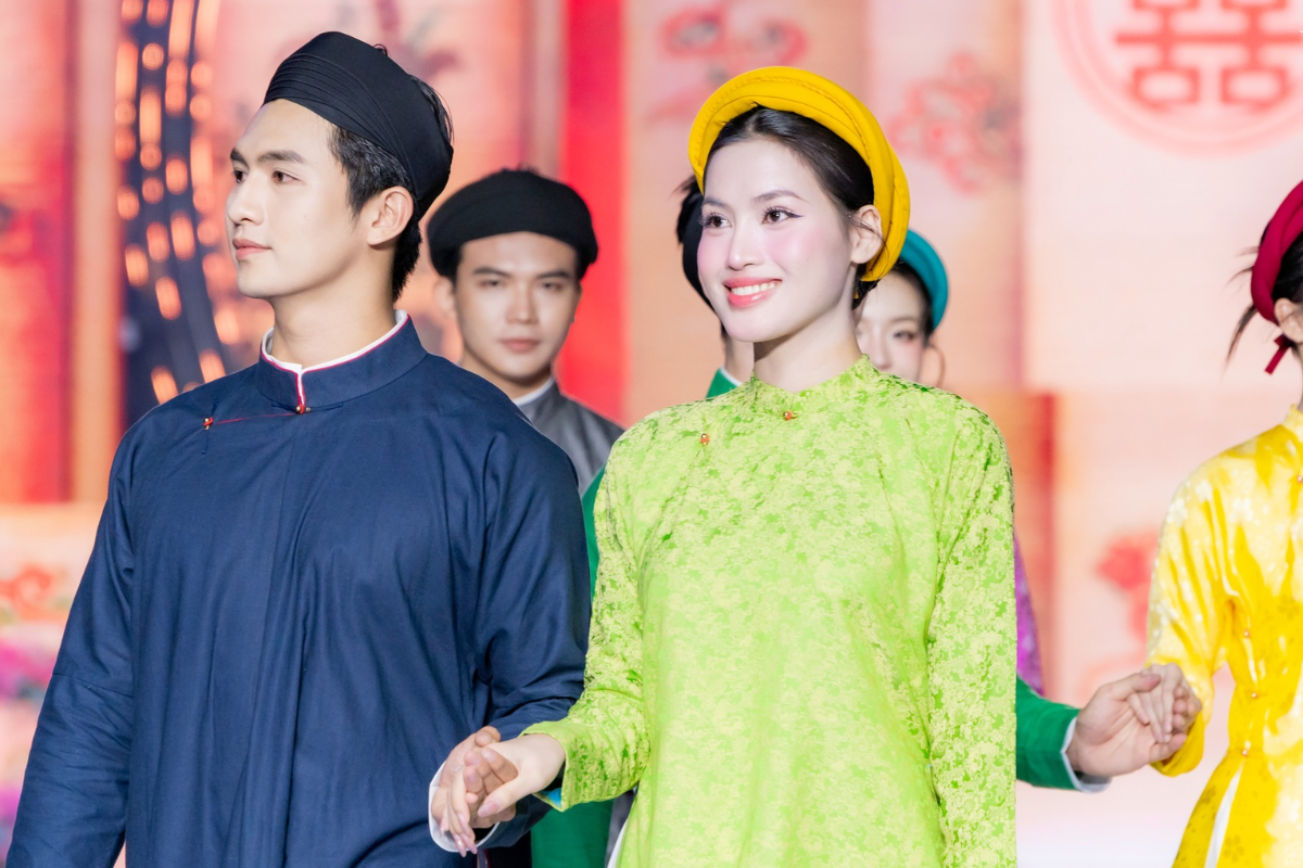Vietnamese women in Ao Dai dresses performing at a festival