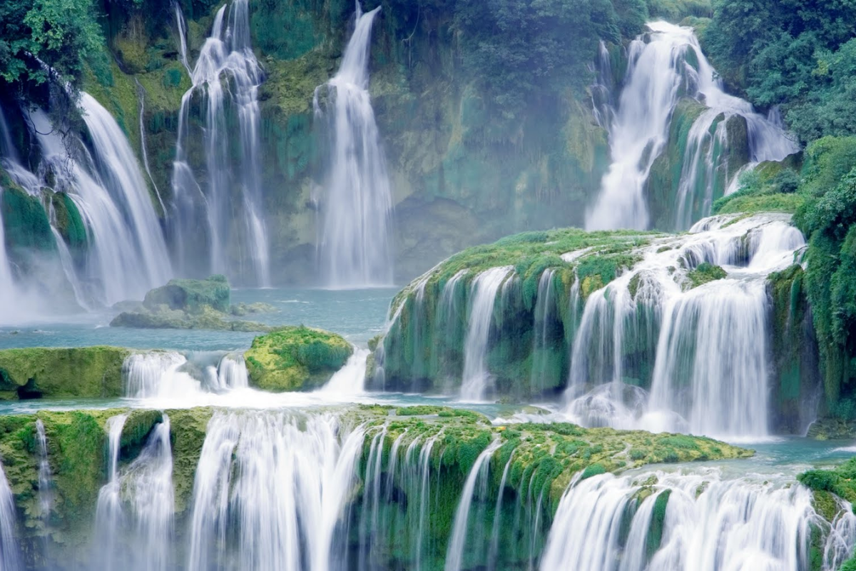 Peaceful Ban Gioc Waterfall covered in light mist during January morning
