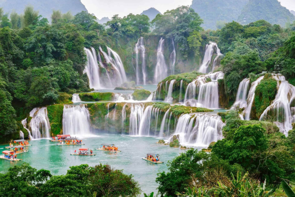 Ban Gioc Waterfall in February with gentle flow and misty landscape