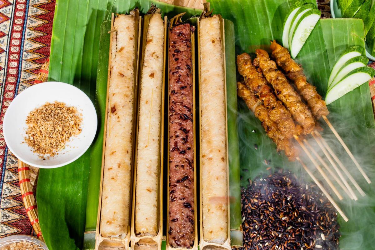 Sticky rice grilled in bamboo tubes served with sesame and grilled pork