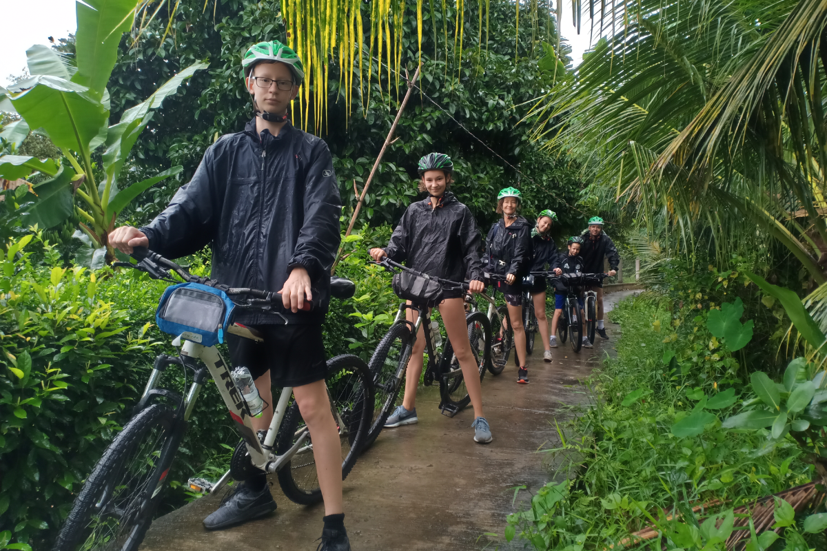 Cyclists riding through the peaceful trails of Can Gio Mangrove Forest near Ho Chi Minh City