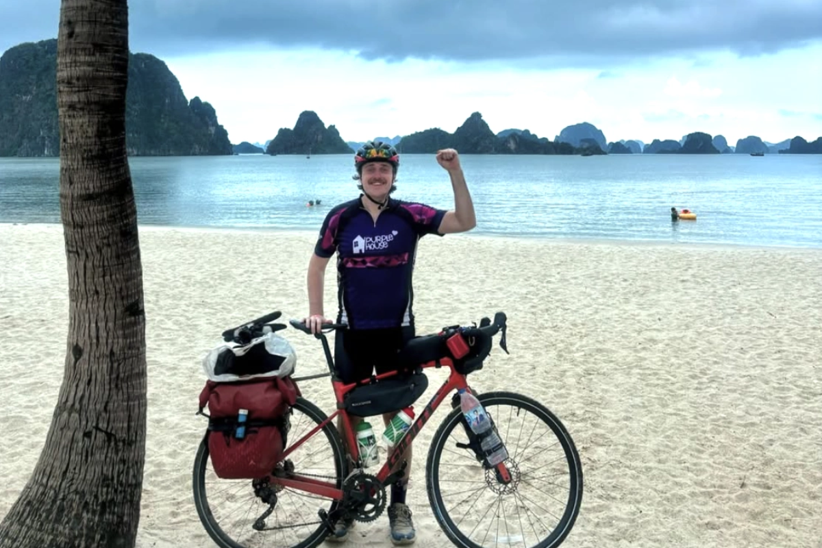 Cyclist on Cham Island coastal road with sea view