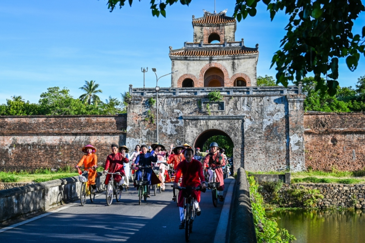 Cyclist in front of Imperial Citadel in Hue