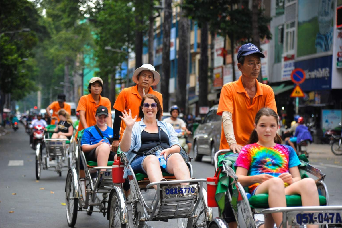 Tourists enjoying a cyclo ride in Ho Chi Minh City