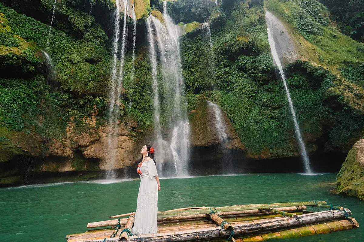 Dai Yem Waterfall flowing through green forest in Moc Chau