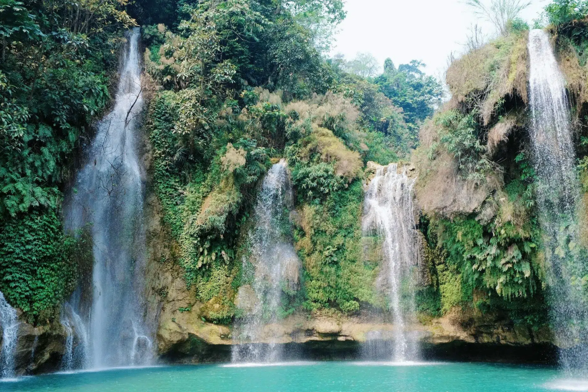 Dai Yem Waterfall with green forest surroundings