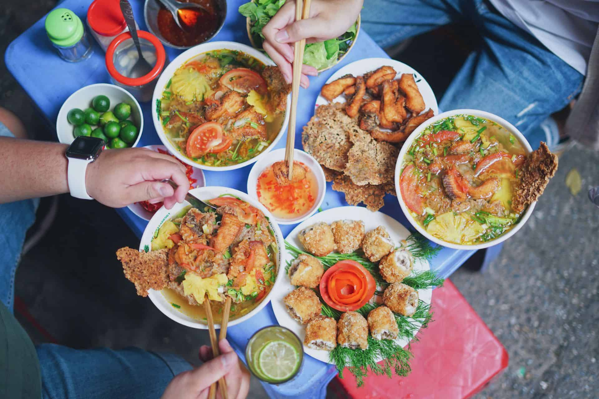 A table of Hanoi street food with Bun rieu cua in cool weather