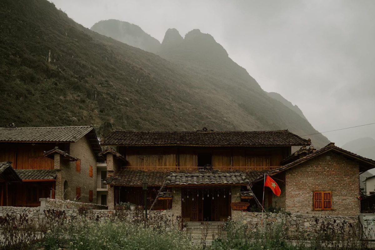Hmong village in the mountains of Ha Giang, surrounded by terraced fields and misty peaks