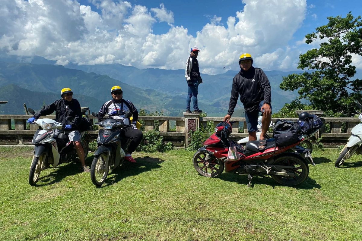 Tourists travel to Ho Village by motorbike