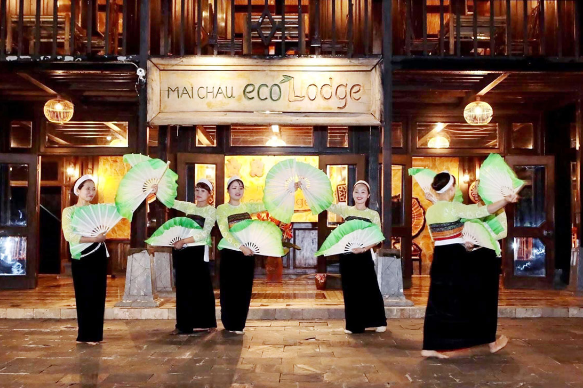 White Thai women performing a traditional dance in Mai Chau