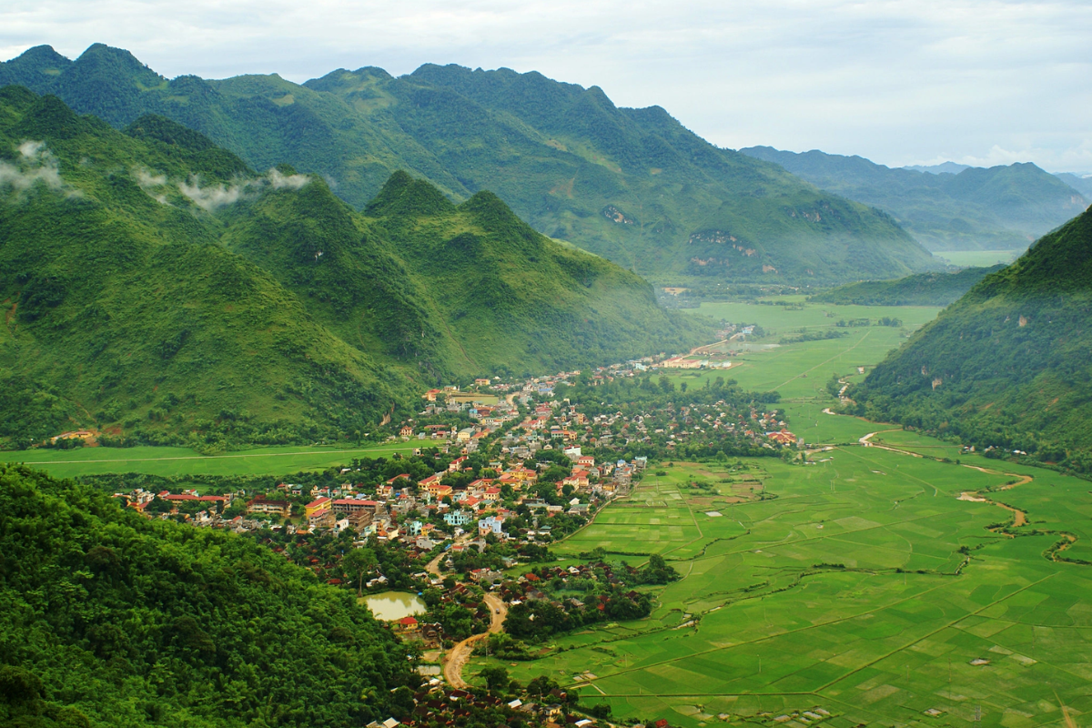 A panoramic view of Mai Chau valley with rice fields and surrounding mountains