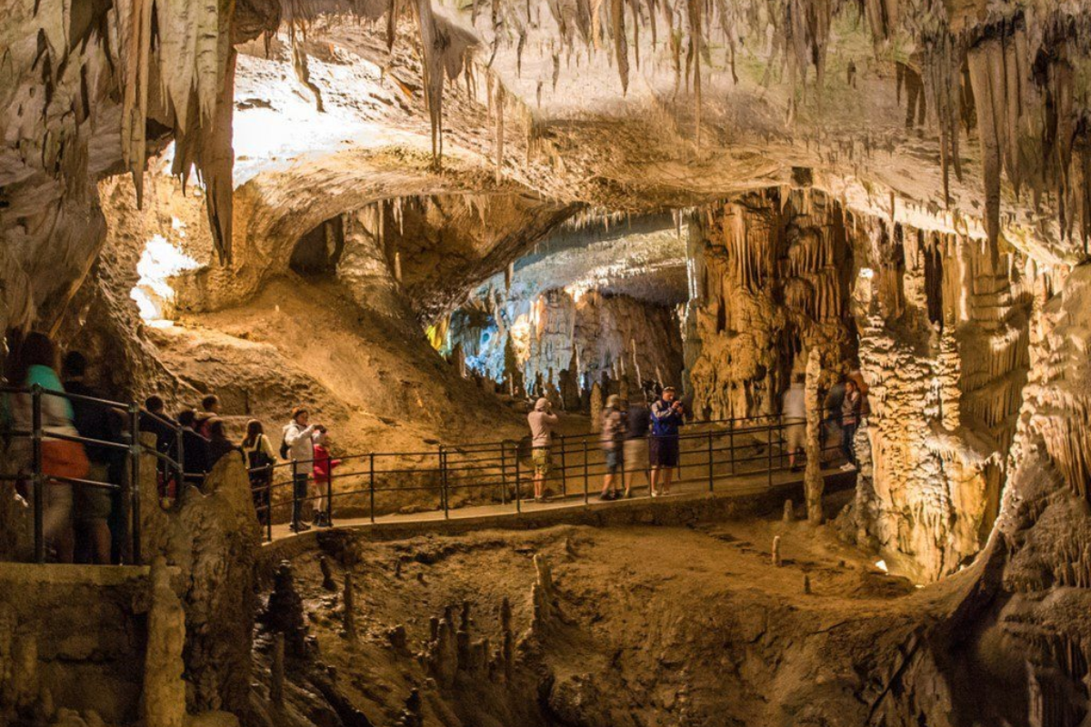 Inside view of Mo Luong Cave with limestone formations and natural light