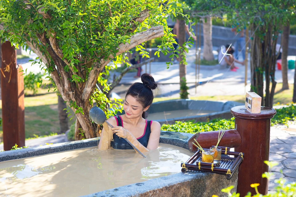 People enjoying outdoor mud baths at Hon Tam Island spa in Nha Trang