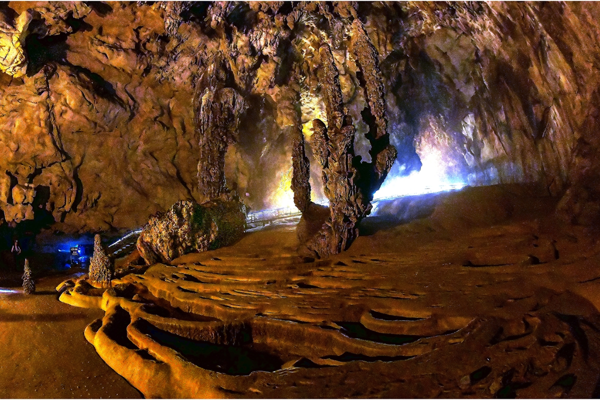 Entrance to Nguom Ngao Cave with limestone rocks and winter lighting