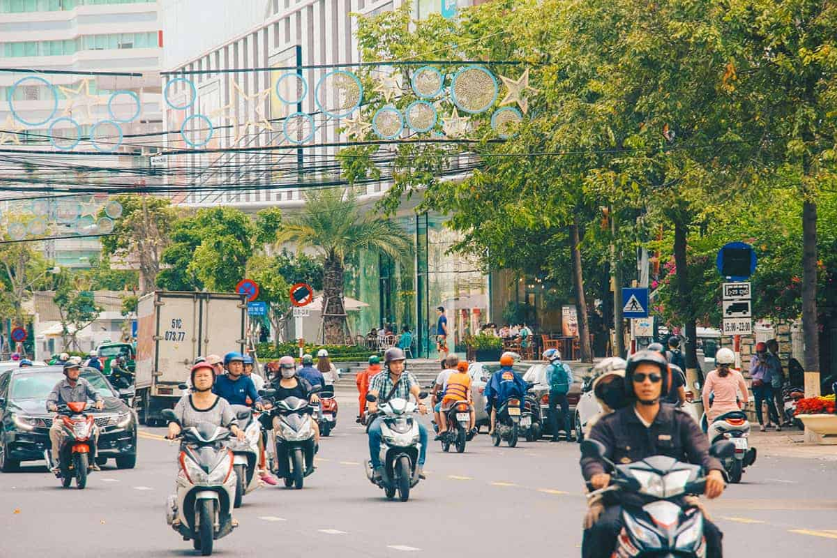 Various transportation options in Nha Trang: motorbikes, taxis, buses, and trains