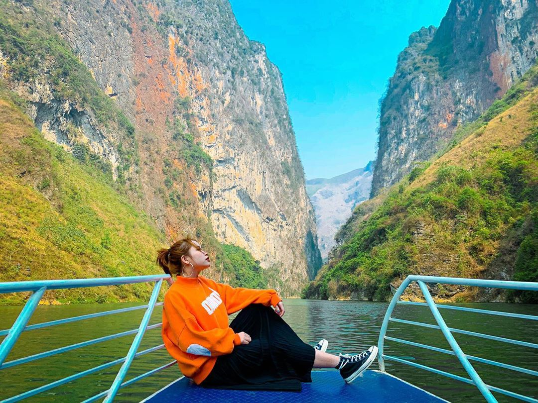 Emerald waters of Nho Que River with steep canyon walls