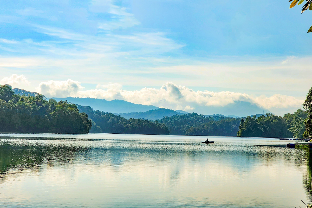 Scenic view of Pa Khoang Lake surrounded by forested hills in Muong Phang commune