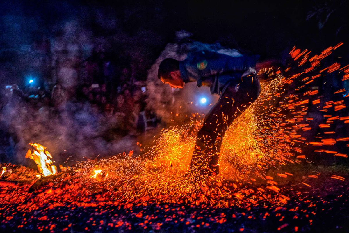 Pa Then men jumping through fire during Fire Dancing Festival in Ha Giang