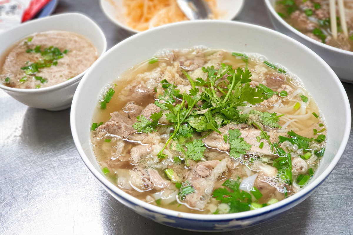 A bowl of steaming Vietnamese pho on a rainy afternoon