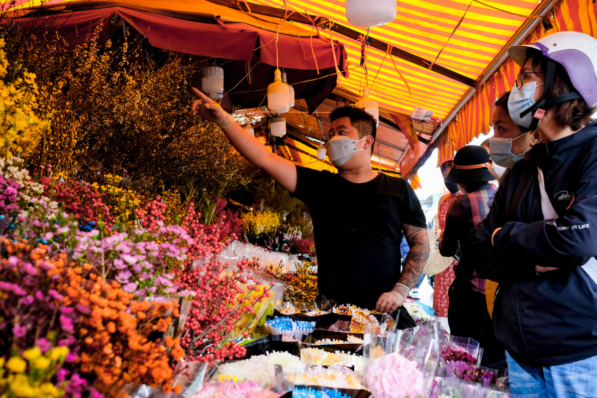 Colorful Tet flower market with peach blossoms in Hanoi