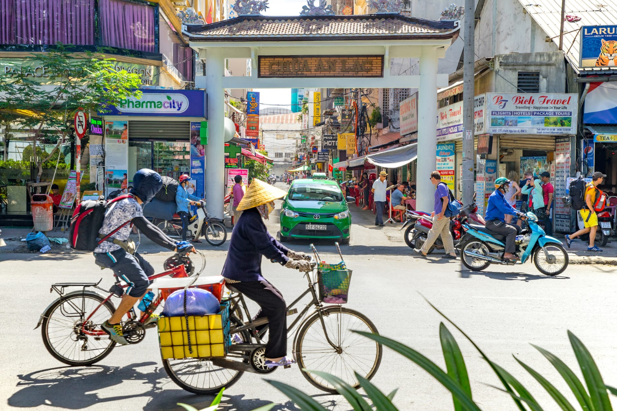 Sunny street scene in Ho Chi Minh City in April with motorbikes