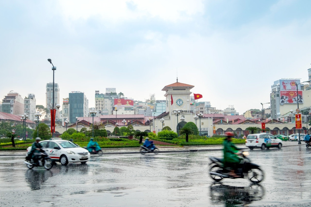 Rainy street in Ho Chi Minh City with locals