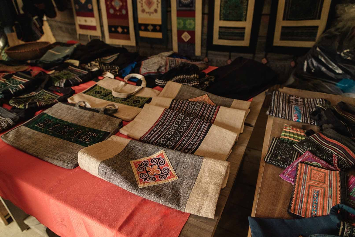 Colorful handmade brocade bags and traditional textiles for sale in Sapa