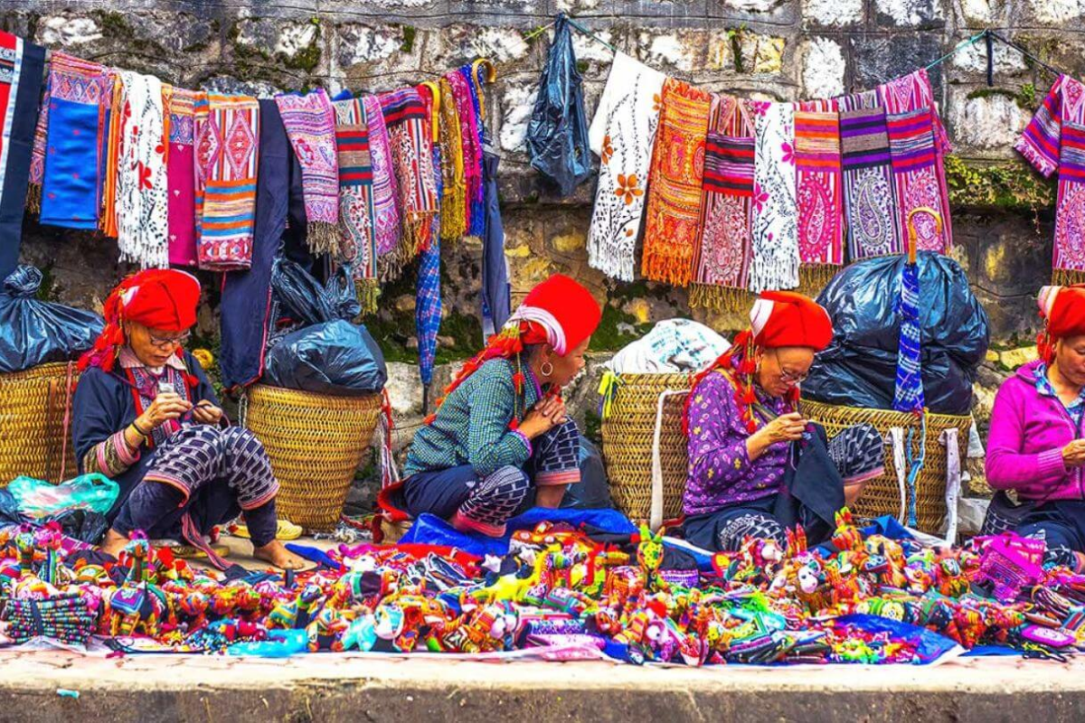 Bustling ethnic market in Sapa with colorful traditional clothes and handmade goods