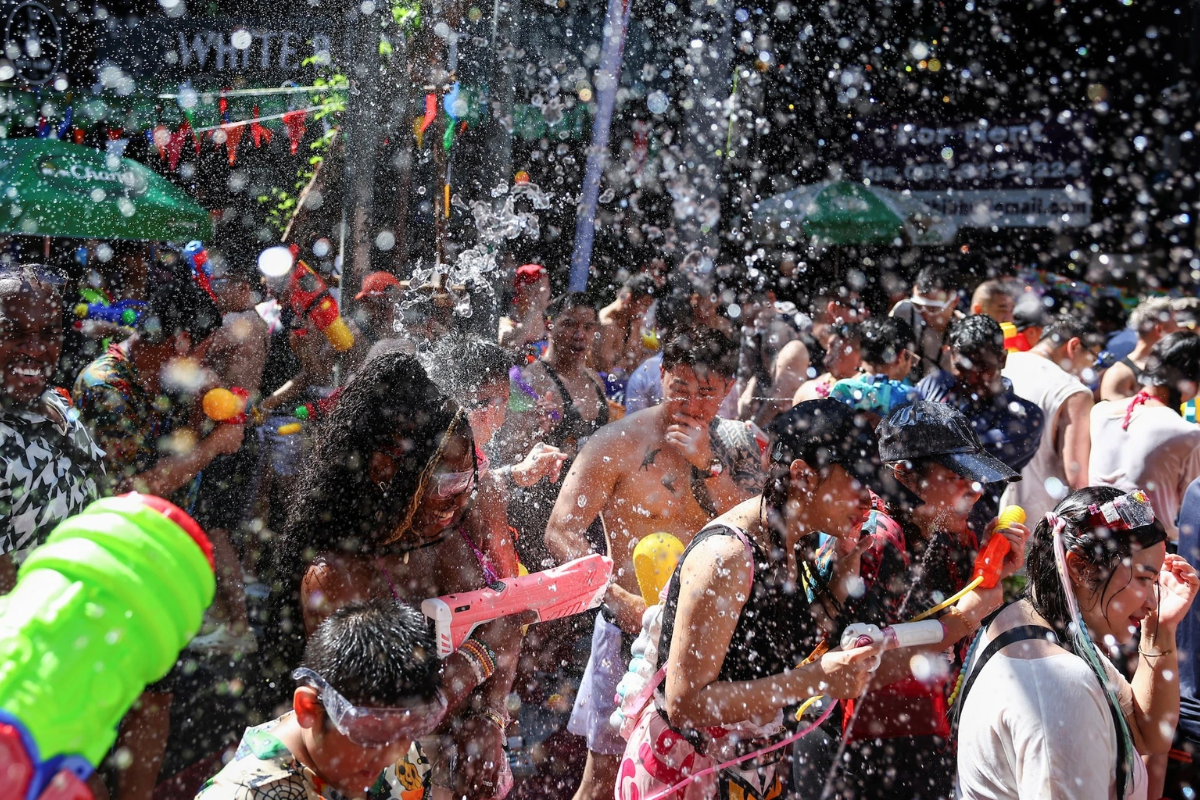 Crowds enjoying Songkran water festival in busy Thai streets