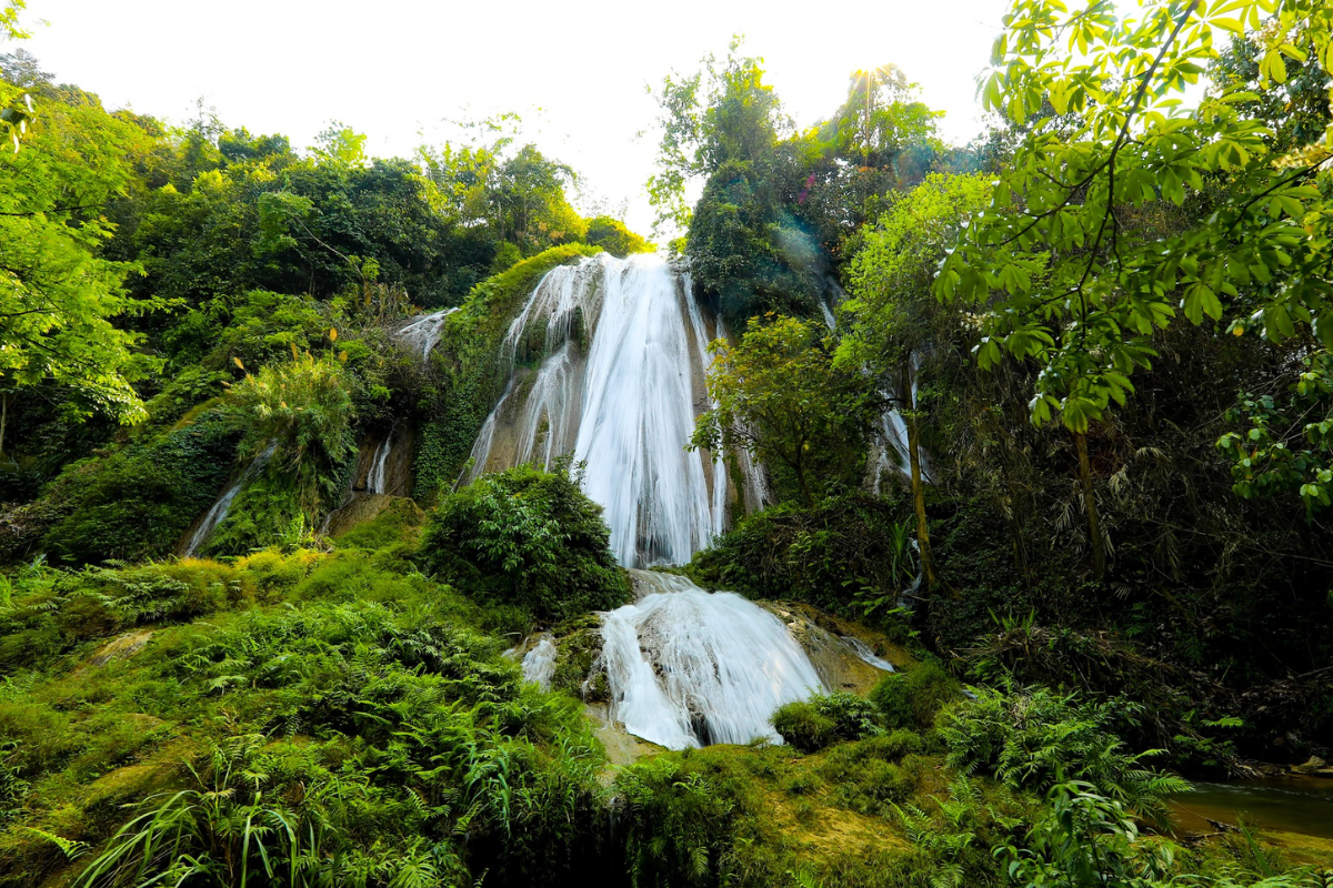 Clear water tumbling down rocks at Tat Nang Waterfall in Moc Chau