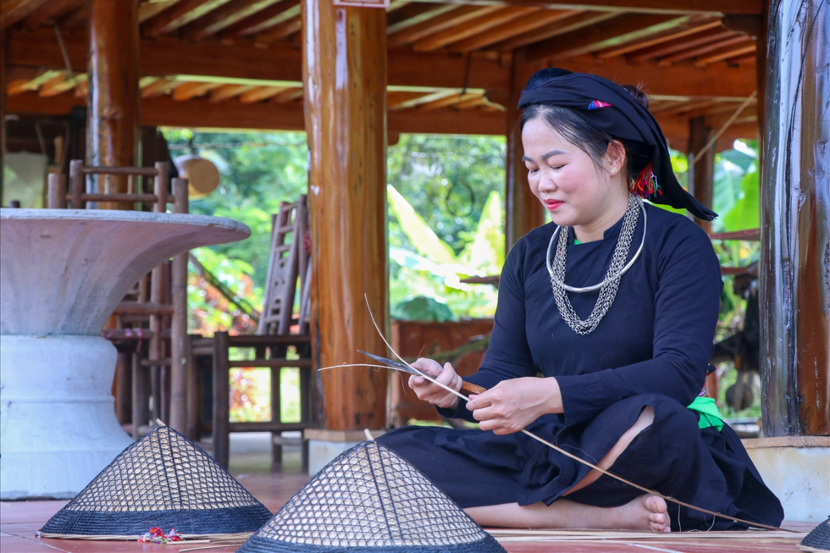 Tay woman weaving conical hat