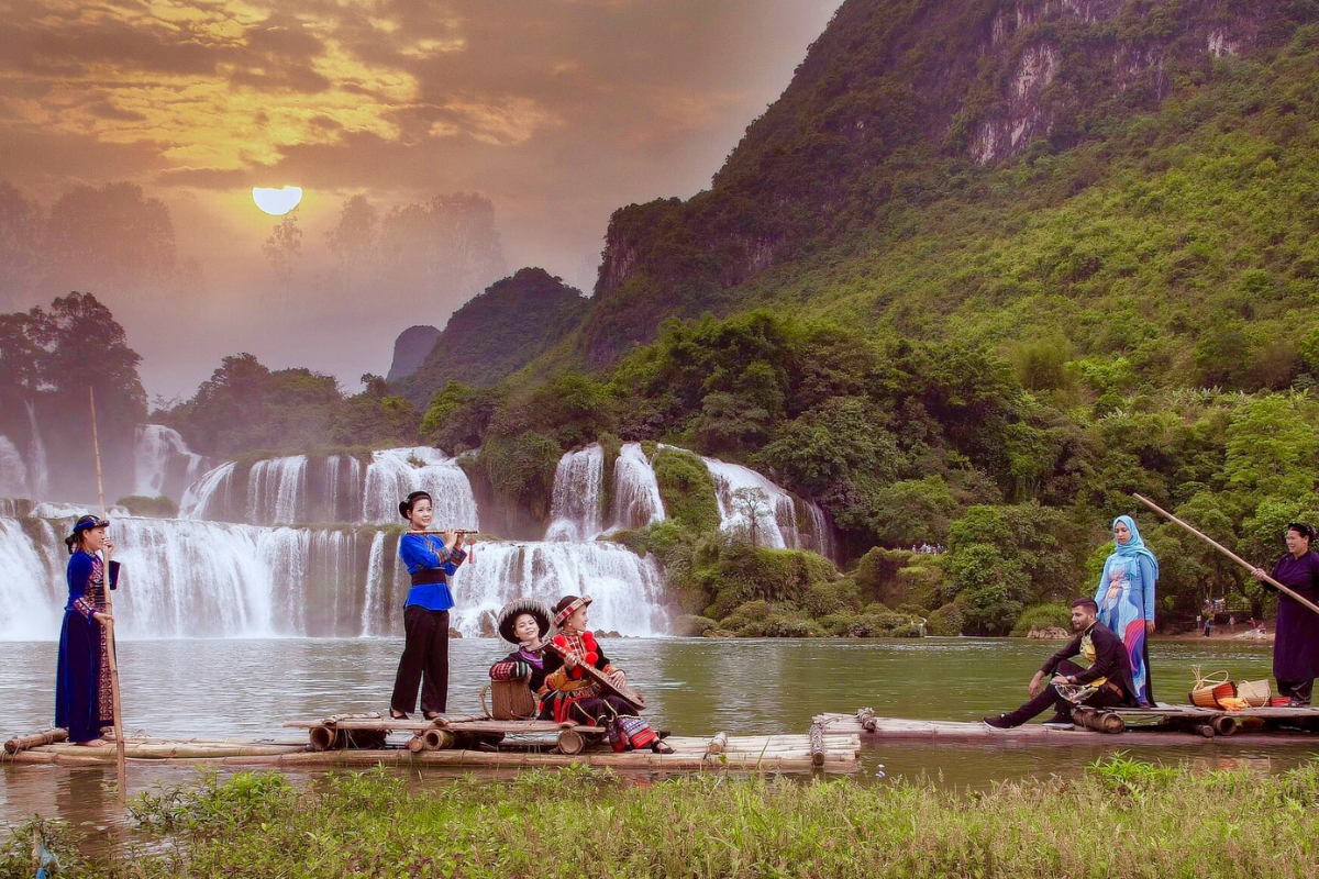 Tourists on a bamboo boat getting close to Ban Gioc Waterfall in September