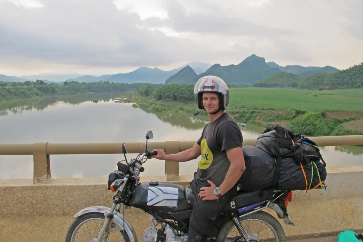 Motorcyclist riding through mountain roads in Vietnam